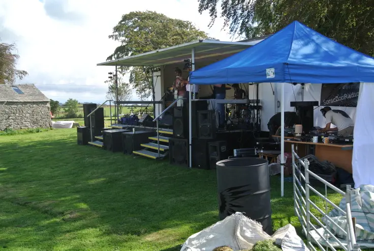 A temporary outdoor structure being prepared during the historic Magic Orchard chapter